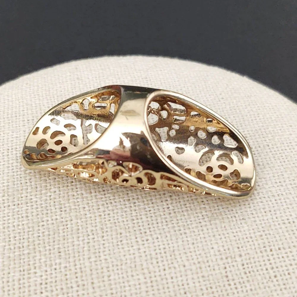 Long, open scroll design gold ring